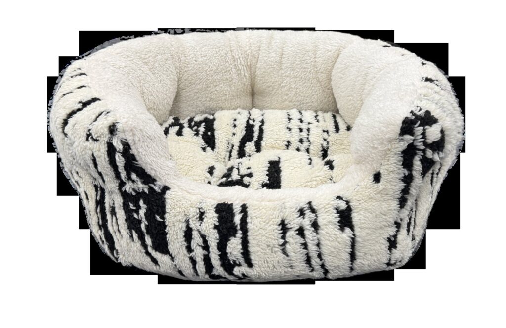 Round cream and black plush pet bed